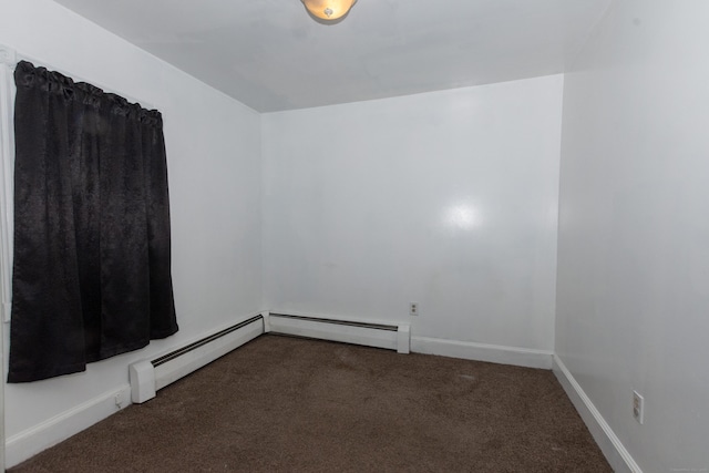 empty room featuring carpet flooring, a baseboard heating unit, and baseboards