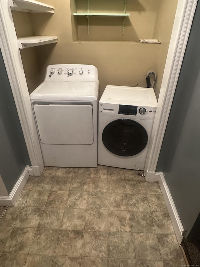 laundry room featuring laundry area, independent washer and dryer, and baseboards