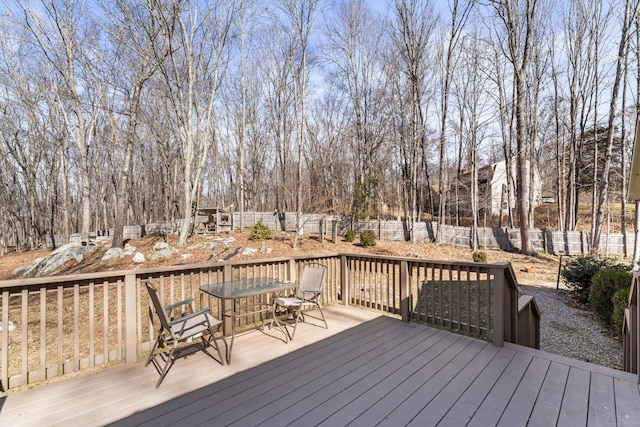 wooden deck featuring outdoor dining space and a fenced backyard