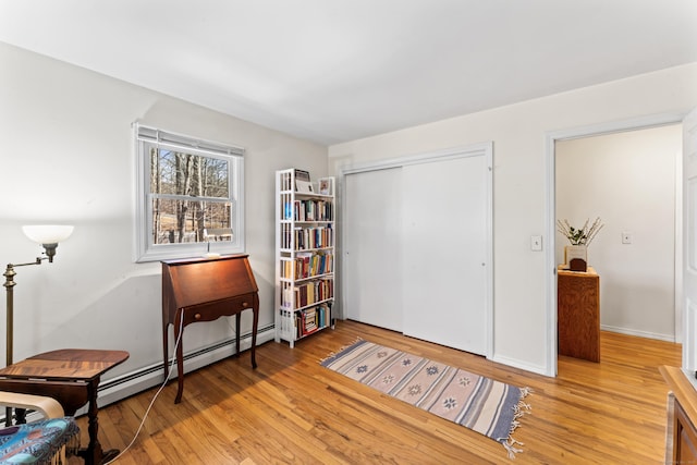 living area with light wood-style flooring and baseboards