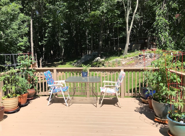 wooden terrace featuring outdoor dining space