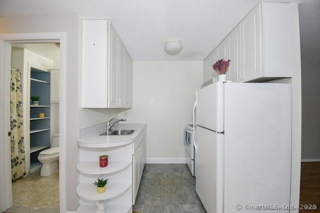 kitchen featuring a sink, light countertops, white cabinets, white appliances, and open shelves