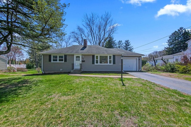 9 Waters Ave, Rocky Hill, CT 06067 - view of front facade featuring a chimney, an attached garage, aphalt driveway, and a front yard