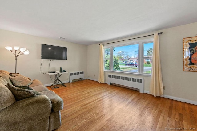 9 Waters Ave, Rocky Hill, CT 06067 - living area featuring radiator, light wood-style flooring, and baseboards