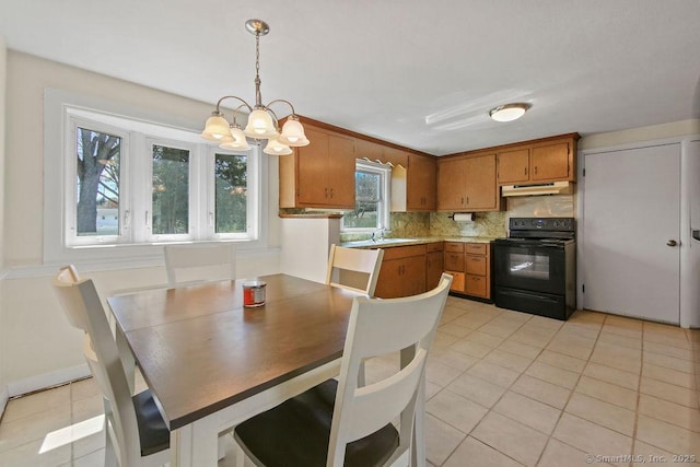 9 Waters Ave, Rocky Hill, CT 06067 - dining area featuring light tile patterned floors and a chandelier