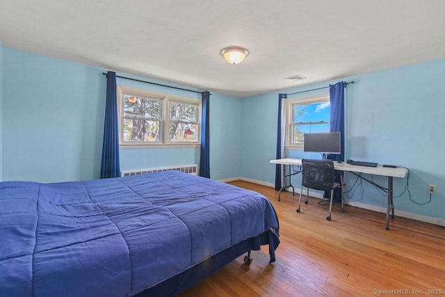 9 Waters Ave, Rocky Hill, CT 06067 - bedroom with visible vents, baseboards, wood finished floors, and radiator
