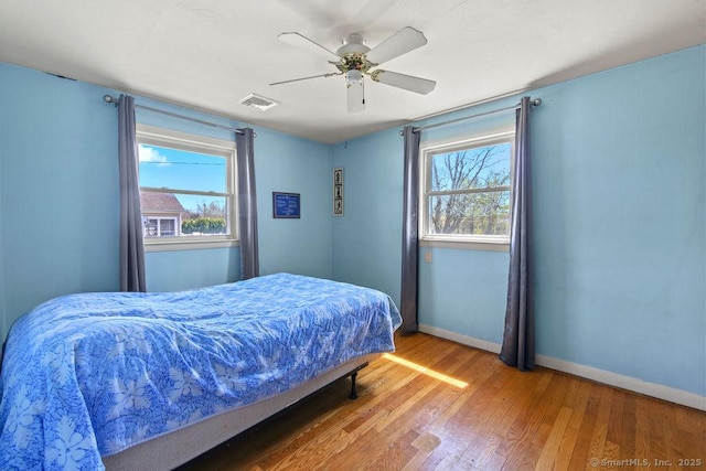 9 Waters Ave, Rocky Hill, CT 06067 - bedroom with visible vents, baseboards, wood finished floors, and multiple windows