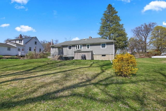 9 Waters Ave, Rocky Hill, CT 06067 - rear view of house featuring a lawn and a chimney