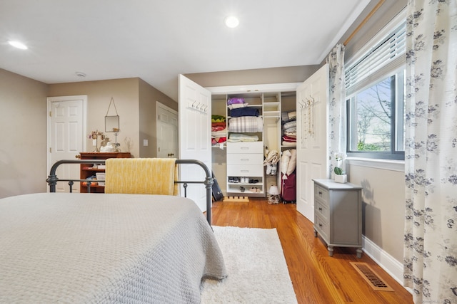 bedroom featuring light wood-style floors, baseboards, visible vents, and recessed lighting