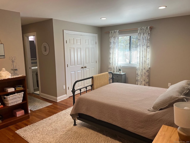 bedroom with connected bathroom, baseboards, dark wood-type flooring, and recessed lighting