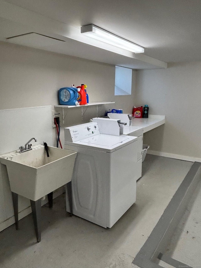 clothes washing area featuring laundry area, baseboards, and washer and clothes dryer