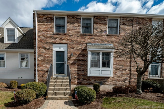 view of front of home featuring entry steps and brick siding