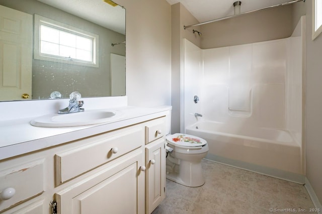 bathroom with washtub / shower combination, vanity, and toilet