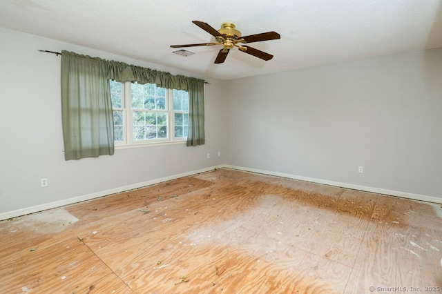 spare room with visible vents, ceiling fan, a textured ceiling, and baseboards