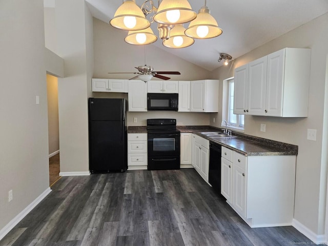 kitchen with dark countertops, white cabinetry, a sink, and black appliances