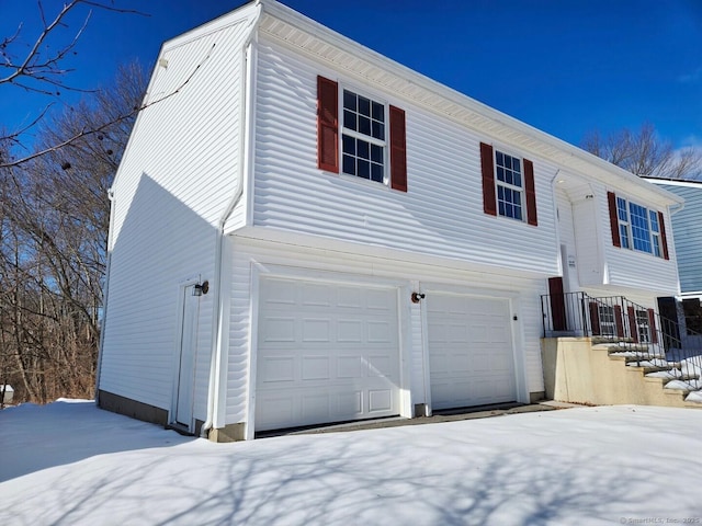 view of snowy exterior featuring an attached garage