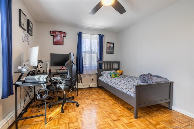 bedroom with baseboards, baseboard heating, and a ceiling fan