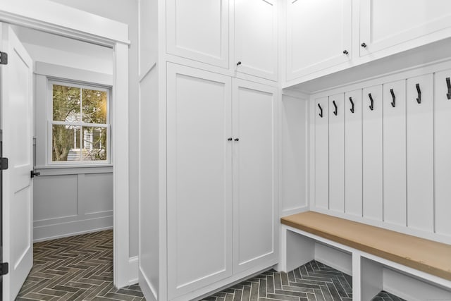 mudroom featuring a decorative wall