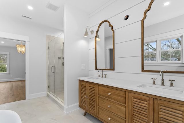 full bath featuring visible vents, a sink, a shower stall, and double vanity