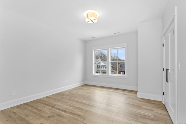 unfurnished bedroom with light wood-style flooring and baseboards