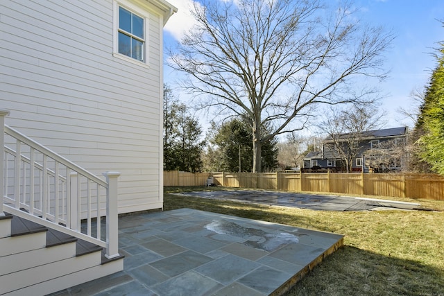 exterior space with a fenced backyard, a patio, and stairway