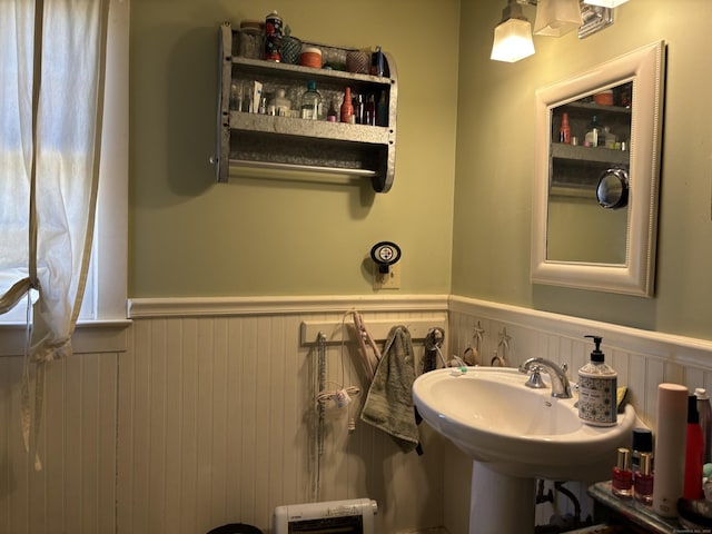 bathroom with a wainscoted wall