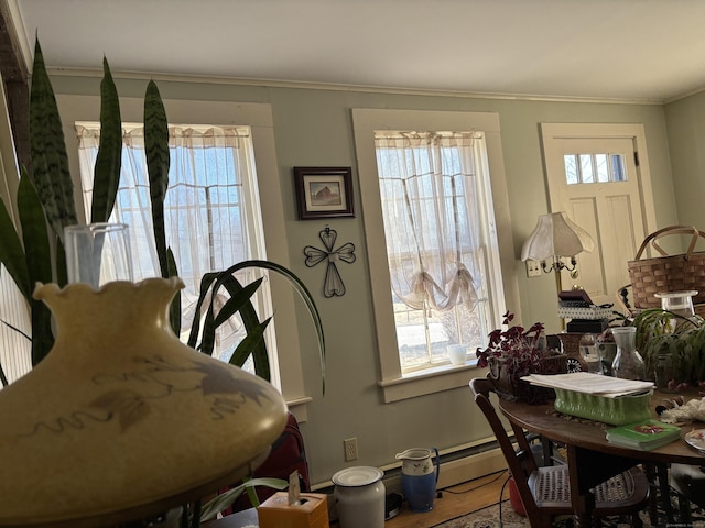 dining area featuring plenty of natural light and crown molding