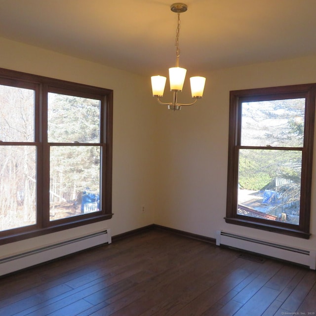 spare room with dark wood-type flooring, a chandelier, baseboard heating, and a baseboard radiator