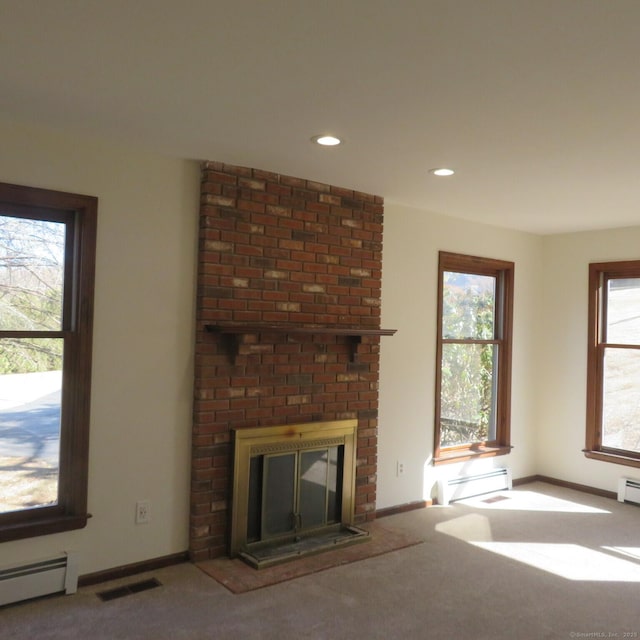 unfurnished living room featuring visible vents, carpet flooring, a fireplace, and a baseboard radiator