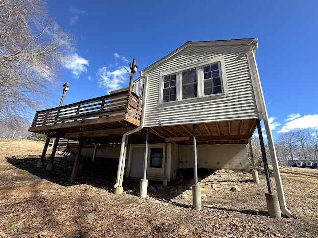 back of property with a wooden deck