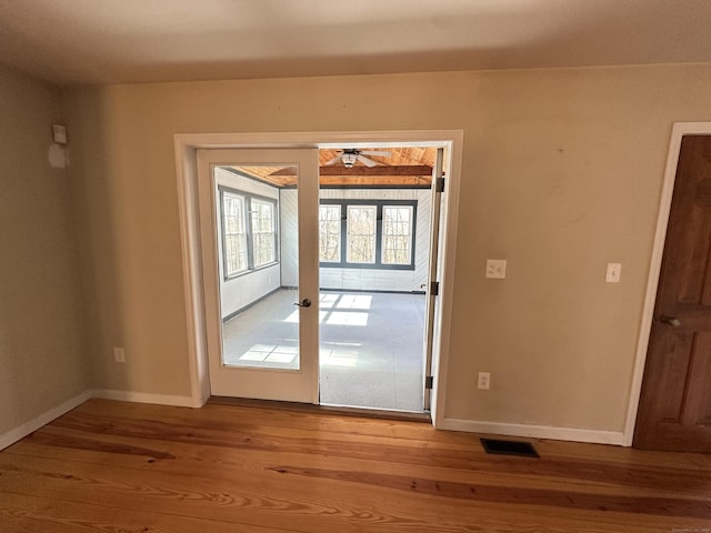 entryway featuring baseboards, visible vents, wood finished floors, and french doors