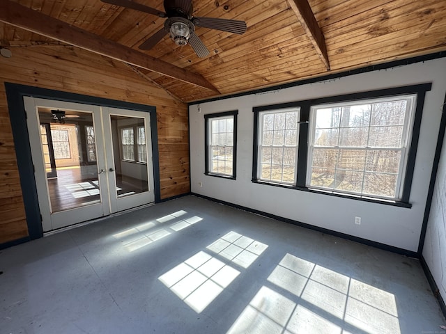 unfurnished room featuring wooden walls, baseboards, wooden ceiling, vaulted ceiling with beams, and french doors