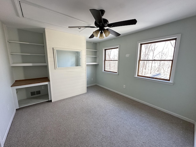 unfurnished bedroom featuring carpet floors, visible vents, baseboards, and a ceiling fan