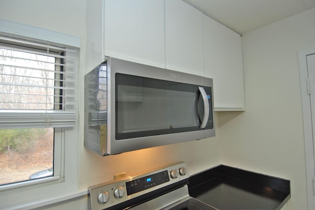 interior details with stainless steel appliances and white cabinetry