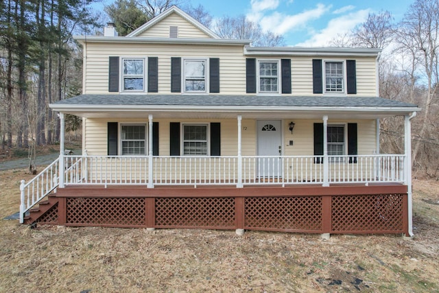 view of front facade with a porch and a shingled roof