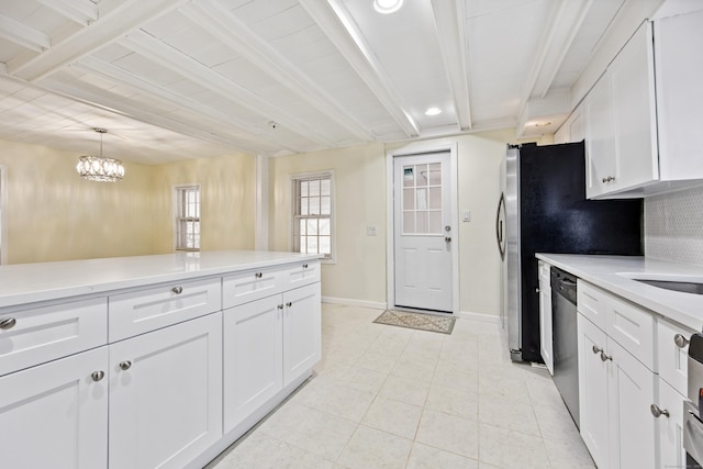 kitchen featuring beam ceiling, dishwasher, white cabinets, and light countertops