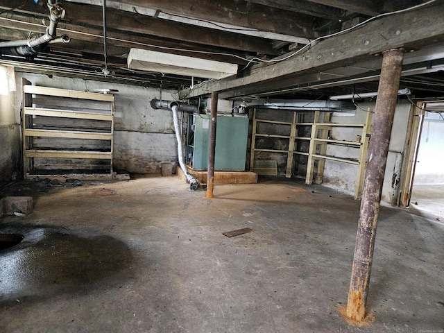 unfinished basement featuring heating unit