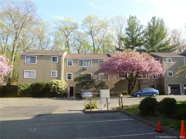 view of building exterior featuring uncovered parking