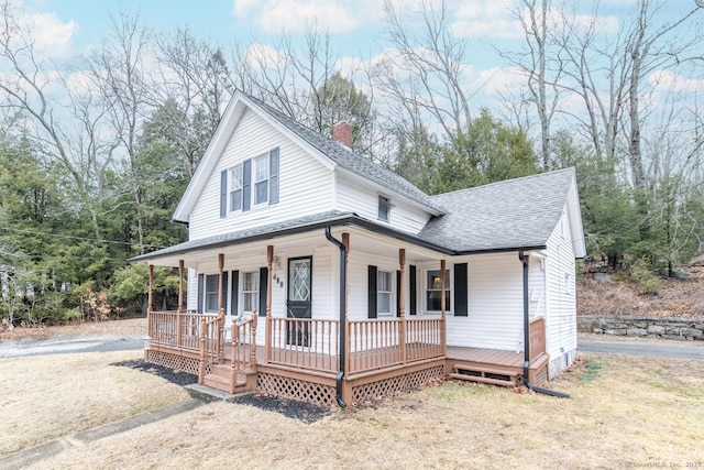 view of front of property with covered porch, roof with shingles, and a chimney