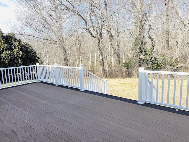 wooden deck with a lawn