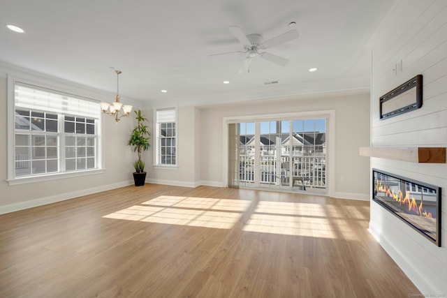 unfurnished living room featuring recessed lighting, a fireplace, baseboards, and wood finished floors