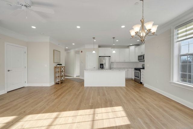 kitchen featuring light wood-style flooring, appliances with stainless steel finishes, ornamental molding, white cabinetry, and a kitchen island