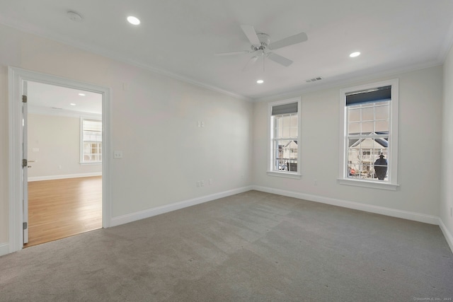 carpeted spare room with baseboards, recessed lighting, a ceiling fan, and crown molding