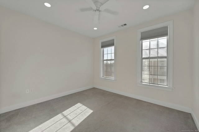 spare room featuring baseboards, visible vents, a ceiling fan, carpet, and recessed lighting