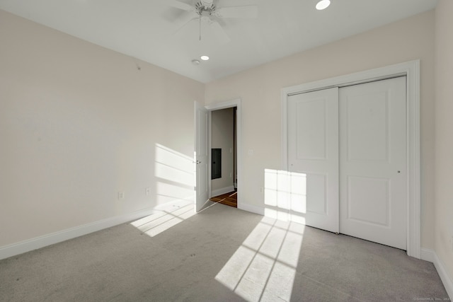 unfurnished bedroom featuring ceiling fan, recessed lighting, baseboards, a closet, and carpet