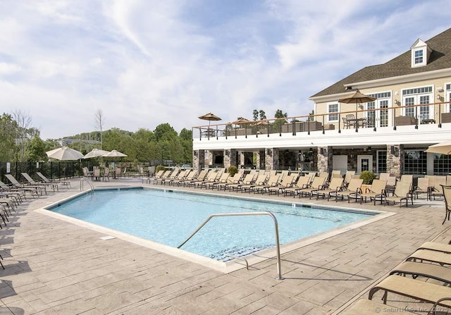 pool featuring a patio area and fence