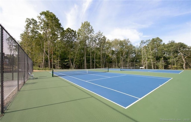 view of tennis court with fence