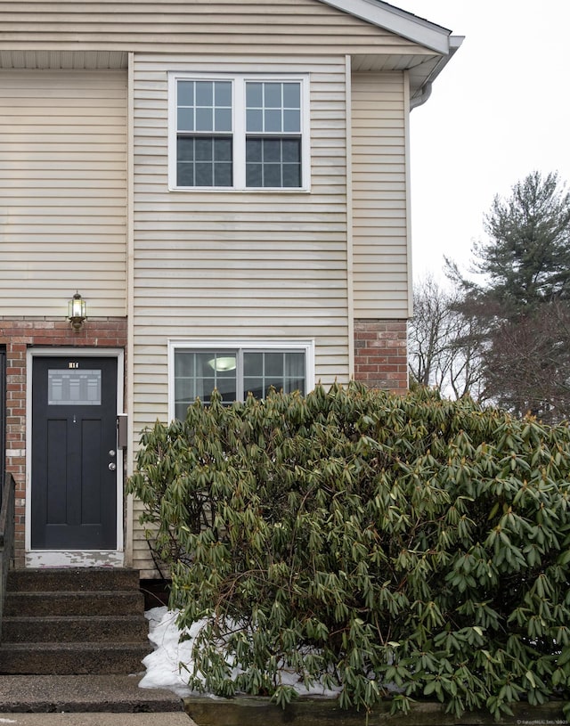 property entrance with brick siding