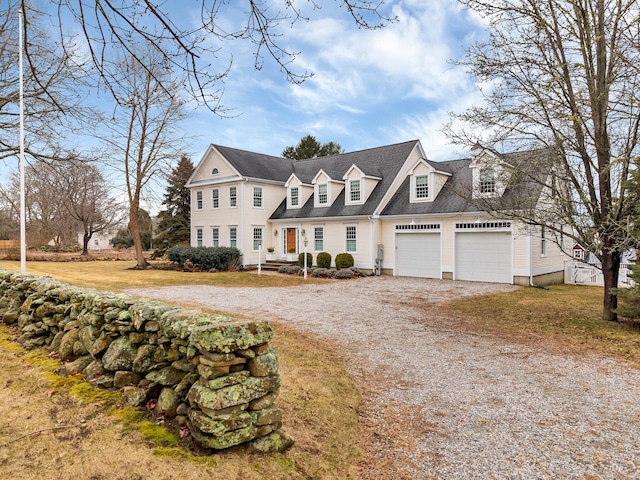 view of front of property with gravel driveway and an attached garage