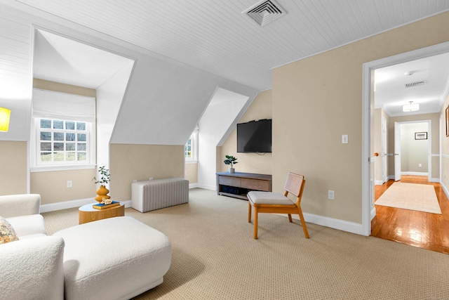 living area featuring a healthy amount of sunlight, carpet, visible vents, and baseboards